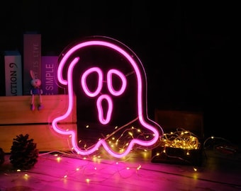 May include: Pink neon ghost light sign with a spooky face. The sign is 30 cm by 28 cm, 40 cm by 37 cm, or 50 cm by 46 cm.