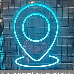 May include: A blue neon sign shaped like a location pin. The sign is 25 inches by 19 inches, 30 inches by 23 inches, or 40 inches by 30 inches.  SIZE: 25*19cm/30*23cm/40*30cm