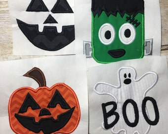 May include: Four Halloween-themed iron-on patches. The patches are on white fabric squares. The patches are a black and gray jack-o-lantern face, a green Frankenstein face, an orange pumpkin face, and a white ghost with the word "BOO" in black.