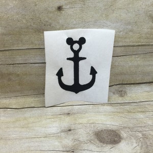 May include: Black iron-on patch with a Mickey Mouse head anchor design.