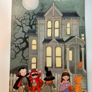 May include: A Halloween sticker fun card with a spooky house, a full moon, and five children dressed in costumes trick-or-treating. The text on the card reads "Halloween Sticker Fun For You!"