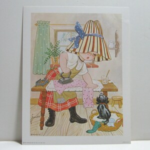 May include: A young girl with a striped hat and a red and black plaid skirt is ironing a pink and white polka dot garment. A black dog sits in a wicker basket next to the ironing board.