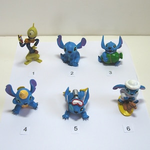 K&ouml;nnte beinhalten: Eine Sammlung von sechs kleinen, farbenfrohen Stitch-Figuren. Die Figuren sind in verschiedenen Posen und Outfits, darunter Tauchausr&uuml;stung und ein Fez. Die Figuren sind haupts&auml;chlich blau mit Akzenten in Gelb, Gr&uuml;n und Wei&szlig;. Die Figuren sind von 1 bis 6 nummeriert.