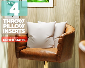 May include: Set of 4 throw pillow inserts made in the United States. The inserts are shown in a brown leather swivel chair with a gold base. The chair is in a room with wood paneling.