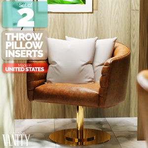 May include: Set of 2 throw pillow inserts. Made in the United States. The inserts are shown in a brown leather swivel chair with a gold base.