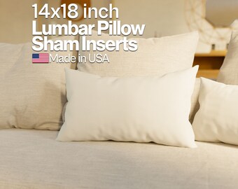 May include: Two white lumbar pillow inserts, 14x18 inches, on a beige couch. The text "14x18 inch Lumbar Pillow Sham Inserts Made in USA" is displayed above the pillows.