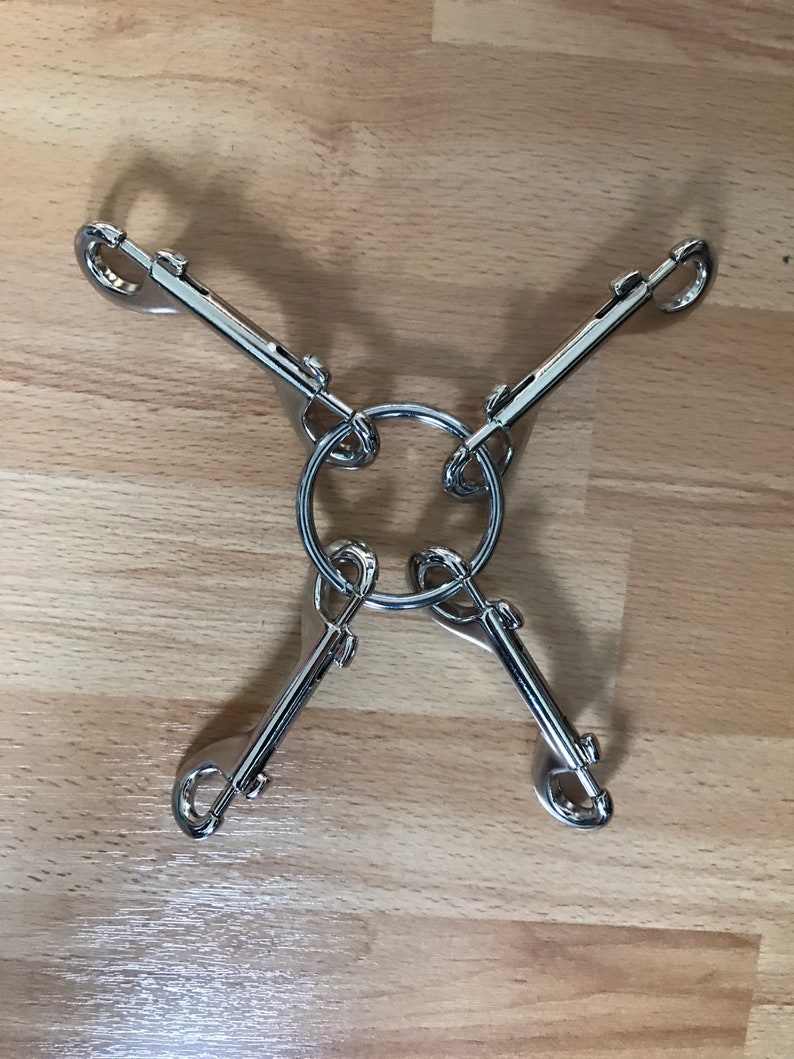 Bondage clips, trigger clips and solid welded rings for fastening restraints, collars, cuffs, BDSM gear for submissive women. 