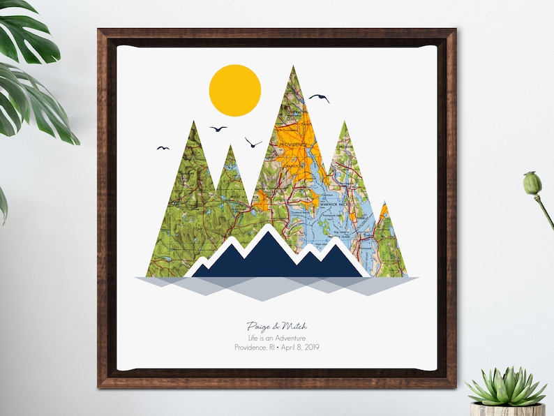 May include: A map of Providence, Rhode Island, is used to create a mountain range design. The mountains are blue, green, and yellow. The text "Paige & Mitch, Life is an Adventure, Providence, RI - April 8, 2019" is at the bottom of the image.
