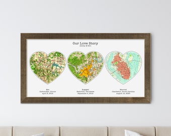 May include: A framed print with three heart-shaped maps representing a couple's love story. The maps are labeled "Met", "Engaged", and "Married" with the corresponding cities and dates. The text reads "Our Love Story Ashley & Brit".