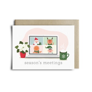 May include: A Christmas card with a laptop screen displaying festive cartoon characters: Santa, a reindeer, a gingerbread person, and an elf. A poinsettia in a red pot and a green mug with a snowflake design are also shown. The text "season's meetings" is below the laptop.