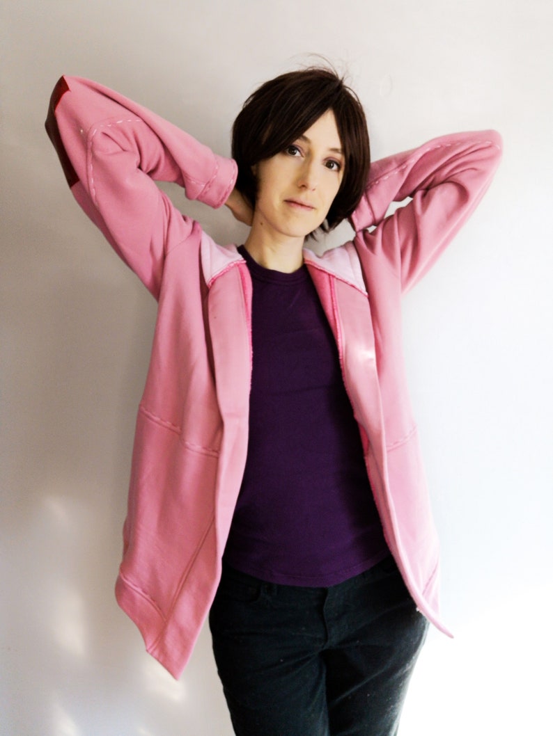 May include: A set of three ceramic mugs with a speckled, matte finish. The mugs are in shades of cream, light gray, and dark gray. Each mug has a simple, minimalist design and a rounded handle.