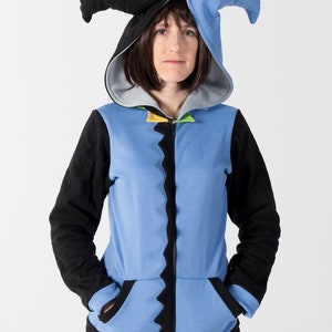 May include: A blue and black hooded sweatshirt with a jester-style hood. The sweatshirt has a zipper closure, black sleeves, and a light blue body with a jagged black trim. The hood is black and blue.