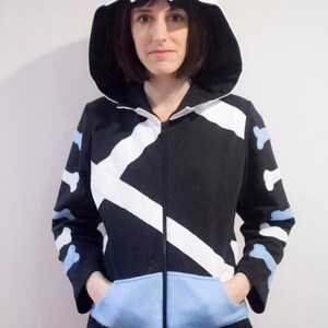 May include: A black and white hooded sweatshirt with a blue pocket and white bone-shaped designs on the sleeves.