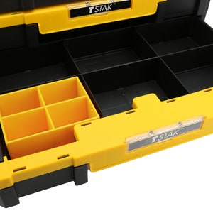 May include: A black and yellow tool box with a T-STAK label. The box has multiple compartments and a removable tray with smaller compartments.
