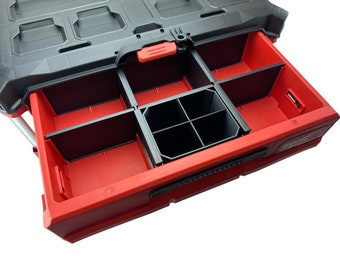 Puede incluir: Caja de herramientas roja y negra con un cajón que tiene varios compartimentos. El cajón está abierto y los compartimentos están vacíos.