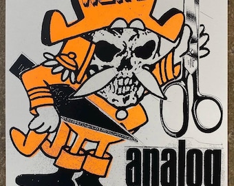 May include: Orange and black graphic art print featuring a skull-faced character wearing a hat with the word "WEIRD" and holding scissors. The text "analog till DEATH" is also included in the design.
