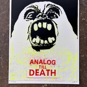May include: A rectangular art print featuring a high-contrast black and white graphic of a screaming face with an open mouth. Below the face, the red text reads ANALOG TILL DEATH. The print includes yellow splatter accents and is numbered 1/50.