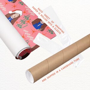Puede incluir: Papel de regalo rosa con un patr&oacute;n repetido de una mujer con cabello largo y casta&ntilde;o que lleva una camisa azul y un gorro de Pap&aacute; Noel rojo. El texto "You can take me" se repite en el papel. El papel se enrolla en un tubo de cart&oacute;n y se etiqueta con "Each sheet of wrapping paper is rolled into a sleeve and shipped in a cardboard tube."