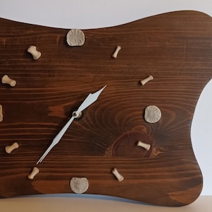 Wooden wall clock with bones