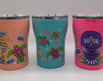Triple-insulated 12 oz. SIC tumbler hand-painted with unique, whimsical designs. Beverages stay ice cold or hot for hours.
