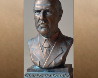May include: A bronze bust of Charles de Gaulle, a French military and political leader. The bust is on a base with the inscription "Charles de Gaulle".