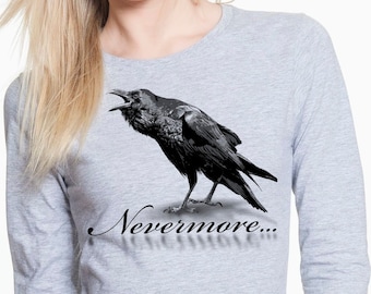 May include: A gray long-sleeved t-shirt with a black raven illustration and the text "Nevermore..." printed on the front.
