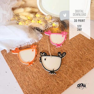 May include: Three colorful, 3D-printed chicken ornaments. One is orange, one is pink, and one is black. Each has a white body and is hanging on a brown surface. The text "DIGITAL DOWNLOAD" and "3D PRINT" is visible.