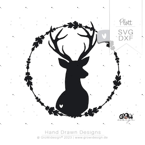 May include: Black silhouette of a deer head with antlers inside a wreath of oak leaves. The design is on a white background with a small heart in the center of the wreath.