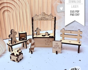 May include: A wooden gingerbread house kit with a sign that reads "Wichtel Lebkuchen". The kit includes a gingerbread house, a gingerbread man, a candy cane, a bench, and a sign that reads "Bin gerade nicht da".
