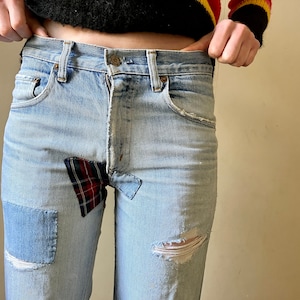 Vintage patched distressed grunge red tab Levi’s.  27/32