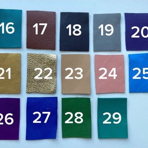 May include: A collection of 14 different colored leather swatches numbered 16 through 29. The swatches are arranged in three rows of four and one row of two.
