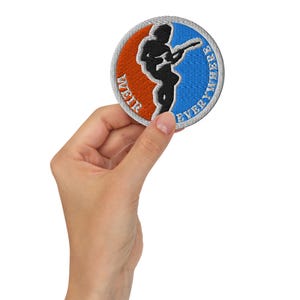 May include: Round embroidered patch with a black silhouette of a person playing a guitar. The patch has a blue and orange background with the words "WEIR" and "EVERYWHERE" in white.