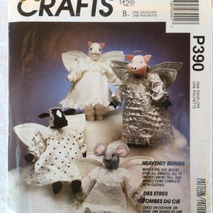 May include: McCall's Crafts pattern featuring four angelic animal figures: a pig, a cat, a mouse, and a cow. Each figure is dressed in angelic attire and measures 15 inches (38cm) tall. The pattern includes instructions for creating these heavenly beings.