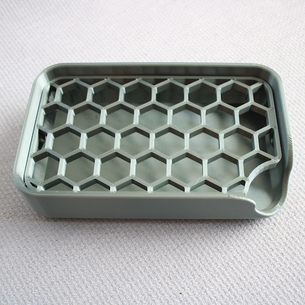 emerald green grey plastic soap dish with alveolate 3D printing - hexagon shiny reflection