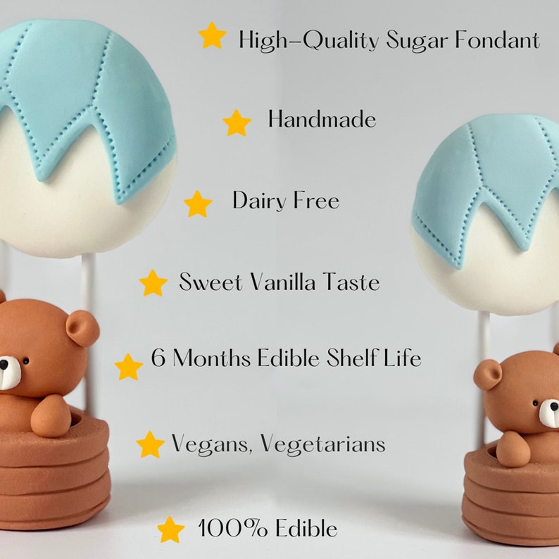 Two edible cake toppers made of sugar fondant, shaped as brown teddy bears holding white and blue round balloons. The toppers are handmade and positioned upright on a white background. Text on the image lists product features.