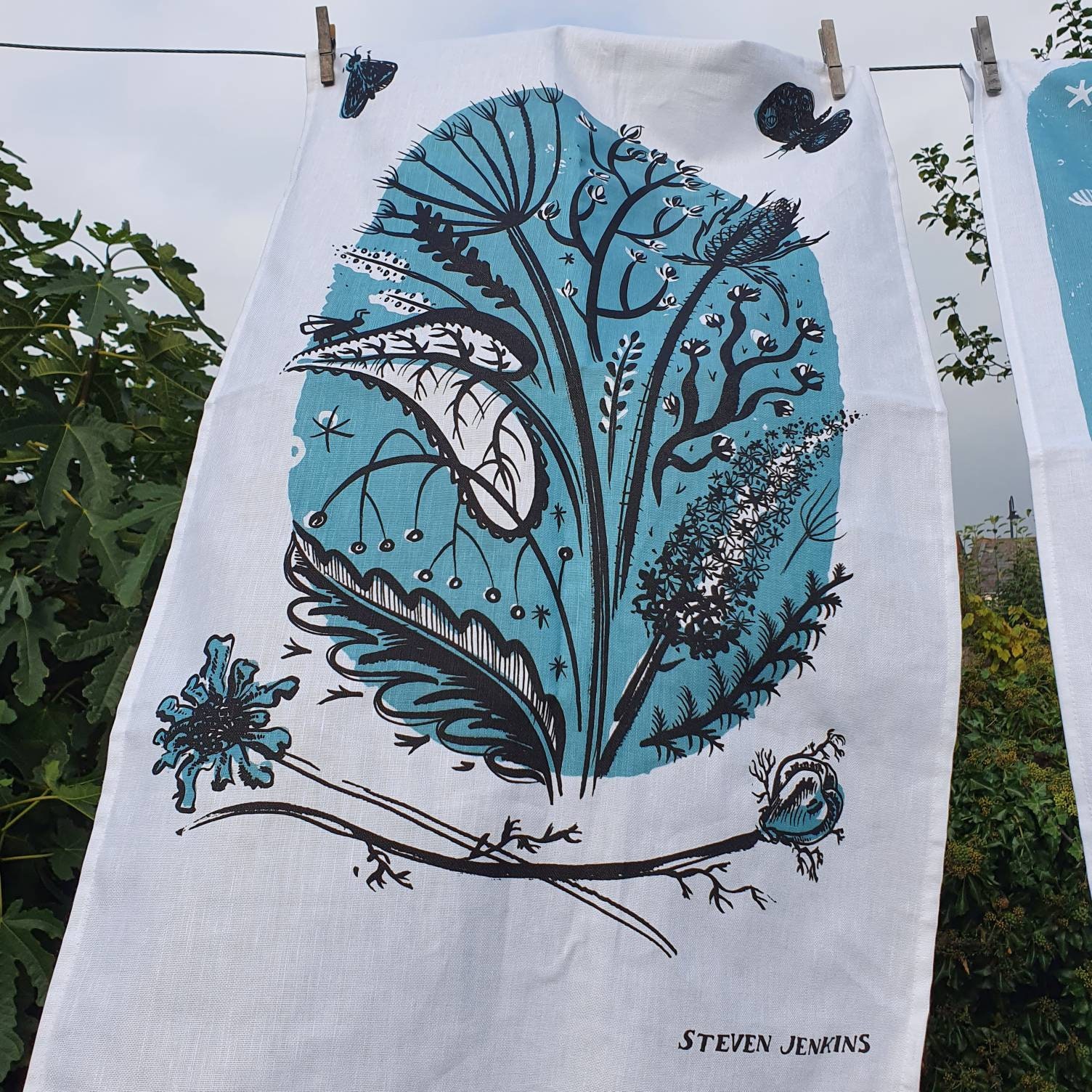 Country Bunch Teatowel in linen union blue/black of buddleia, nigella, scabious, hogweed, moth and butterfly - ink drawing