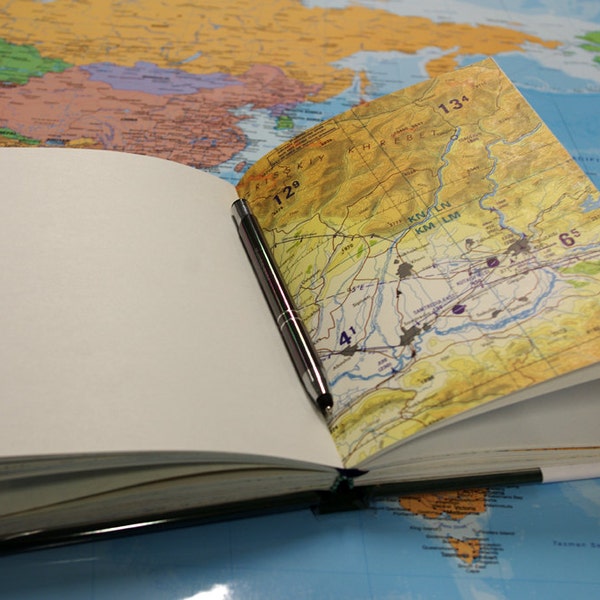 Travel books with maps from various countries throughout