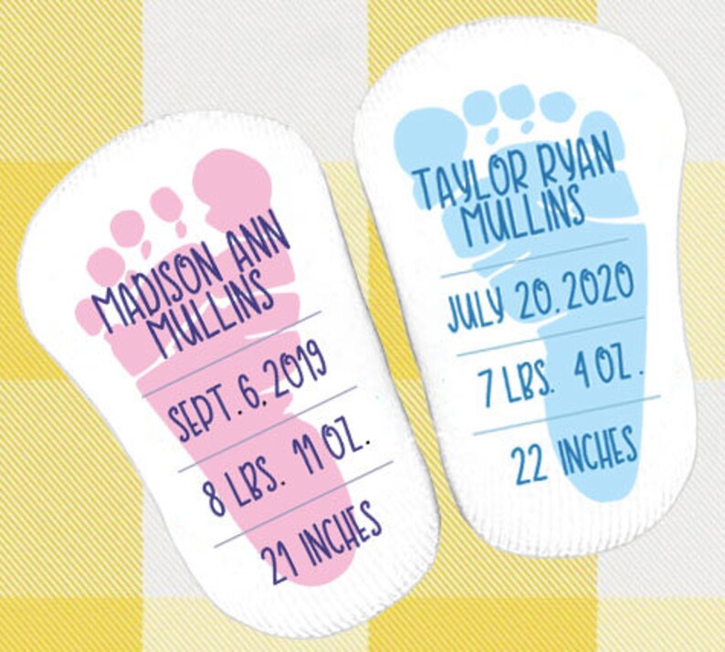 May include: Two baby footprint cards, one pink and one blue, with the names Madison Ann Mullins and Taylor Ryan Mullins, birth dates, weights, and lengths.