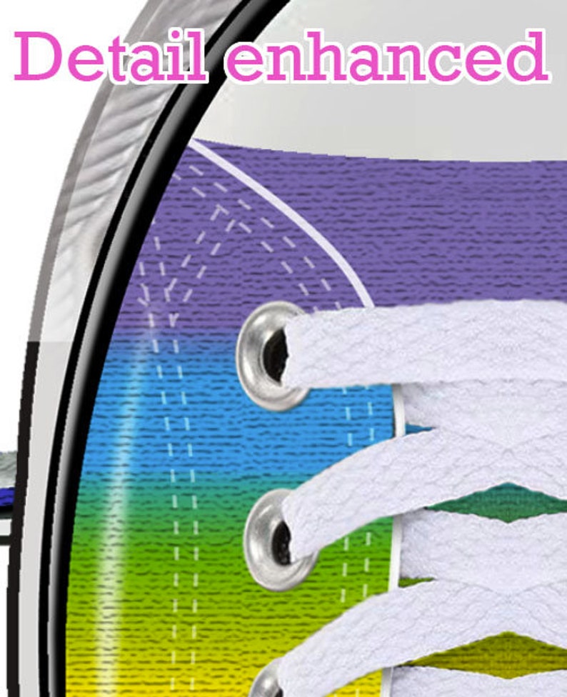 May include: Close-up of a rainbow-colored canvas shoe with white laces. The shoe has a purple, blue, green, yellow, and red stripe pattern. The laces are threaded through metal eyelets.