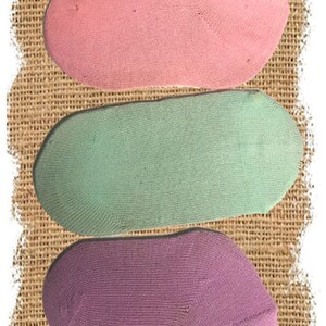May include: Three pairs of ankle socks in different colors: pink, light green, and purple.