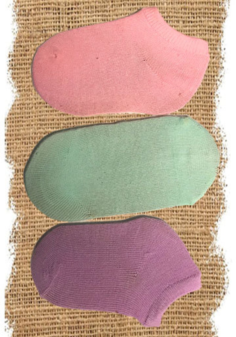 May include: Three pairs of ankle socks in different colors: pink, light green, and purple.