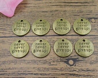 May include: Eight antique gold-toned metal charms with the words "never never give up!" engraved on each charm.