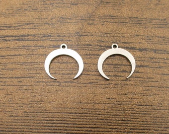 May include: Two silver crescent moon charms with a small loop at the top for attaching to jewelry or other crafts.