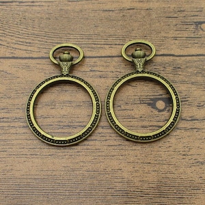 2 colgantes con bisel redondo de 30 mm, marco de medallón, tono bronce antiguo (sin cristal) - TS061