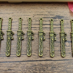 8 Sword Charms,Antique Bronze Tone, Double Sided With Dragons-RS093