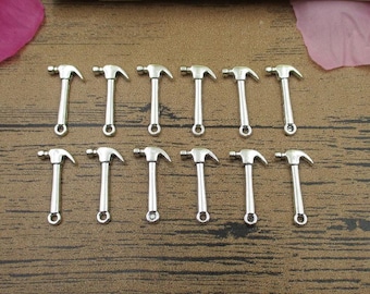 May include: Twelve silver-toned hammer charms, each with a loop for attaching to a necklace, bracelet, or other jewelry project.