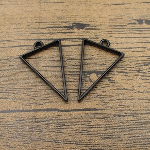 May include: Two black metal triangle pendant frames. The frames are open and have a smooth, shiny finish.