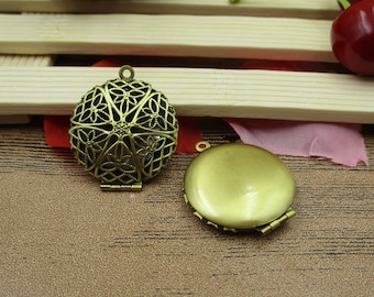 May include: Two antique gold-toned locket pendants. One pendant has a filigree design and the other has a solid gold surface.