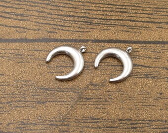 May include: Two silver crescent moon charms with a loop at the top for attaching to jewelry or other crafts.