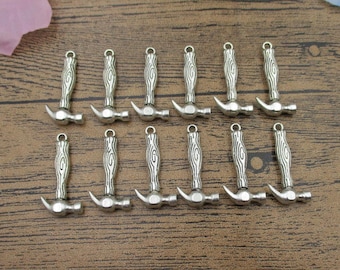 May include: A set of 12 silver-toned hammer charms. Each charm features a detailed hammer design with a textured handle.
